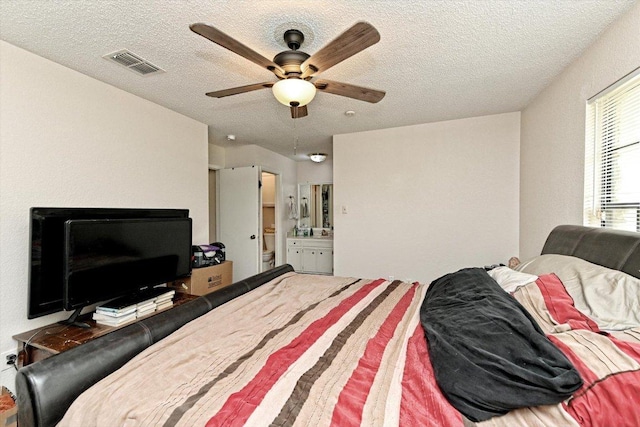 1306 Daytona Dr, Austin, TX 78733 - bedroom featuring a textured ceiling, connected bathroom, and a ceiling fan