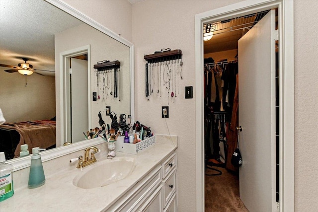 1306 Daytona Dr, Austin, TX 78733 - ensuite bathroom with vanity, a ceiling fan, and a spacious closet