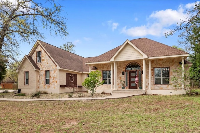 330 Arbors Cir, Elgin, TX 78621 - view of front of house with stone siding, a front yard, and roof with shingles