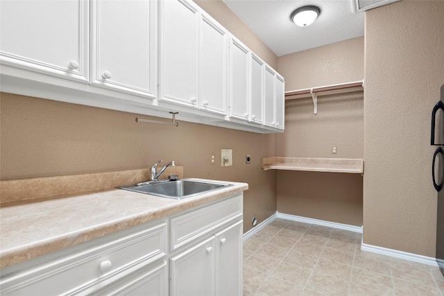 330 Arbors Cir, Elgin, TX 78621 - laundry room with hookup for an electric dryer, cabinet space, baseboards, hookup for a washing machine, and light tile patterned floors