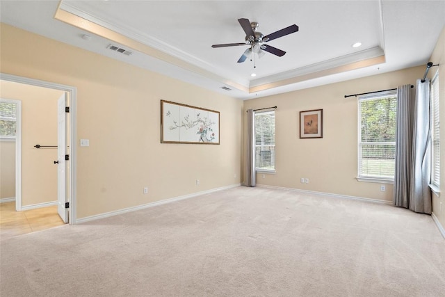 330 Arbors Cir, Elgin, TX 78621 - spare room featuring a tray ceiling, ornamental molding, light carpet, a ceiling fan, and recessed lighting