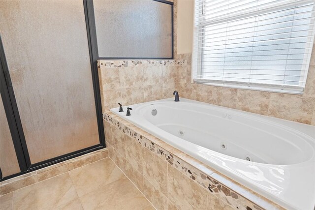330 Arbors Cir, Elgin, TX 78621 - bathroom with a jetted tub, a stall shower, and tile patterned floors