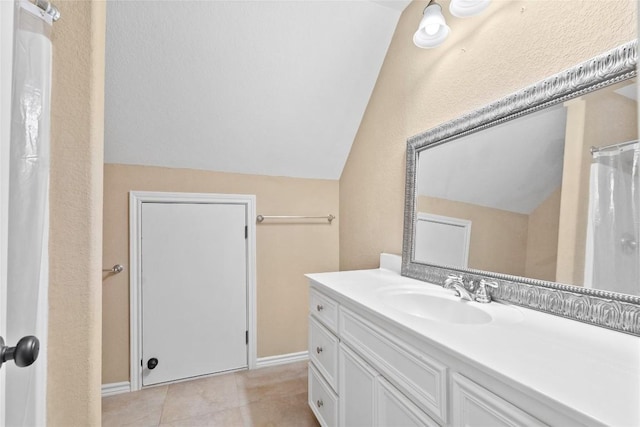 330 Arbors Cir, Elgin, TX 78621 - full bath featuring lofted ceiling, vanity, tile patterned flooring, and baseboards