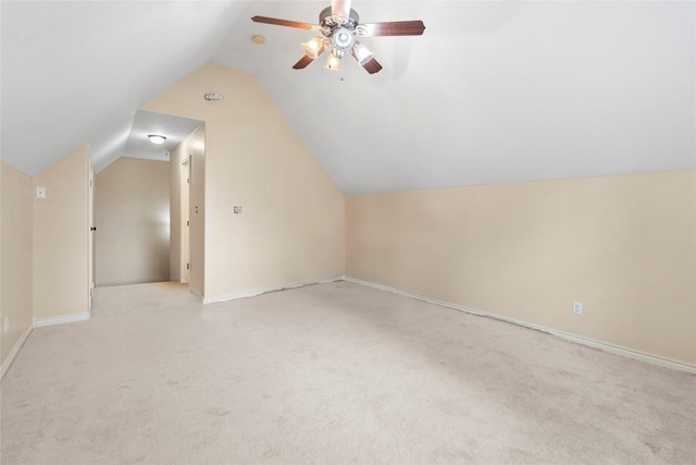 330 Arbors Cir, Elgin, TX 78621 - additional living space with light carpet, lofted ceiling, a ceiling fan, and baseboards