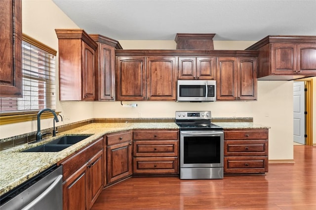 330 Arbors Cir, Elgin, TX 78621 - kitchen with appliances with stainless steel finishes, a sink, light stone countertops, and dark wood finished floors