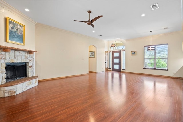 330 Arbors Cir, Elgin, TX 78621 - unfurnished living room with wood finished floors, crown molding, ceiling fan, a fireplace, and baseboards