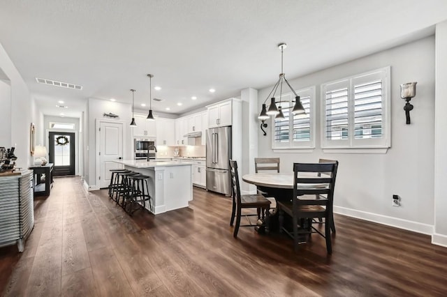 113 Cibolo Creek Loop, Bastrop, TX 78602 - dining space with dark wood-style floors, a chandelier, and recessed lighting