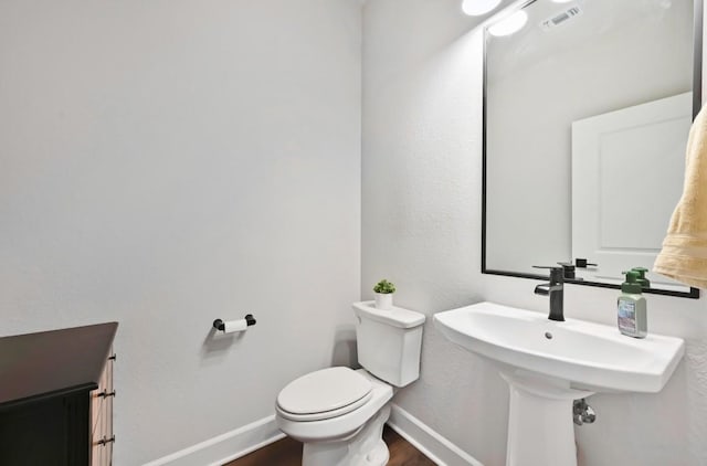 113 Cibolo Creek Loop, Bastrop, TX 78602 - bathroom featuring toilet and wood finished floors