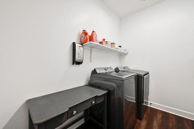 washroom with dark wood-type flooring, baseboards, laundry area, and separate washer and dryer
