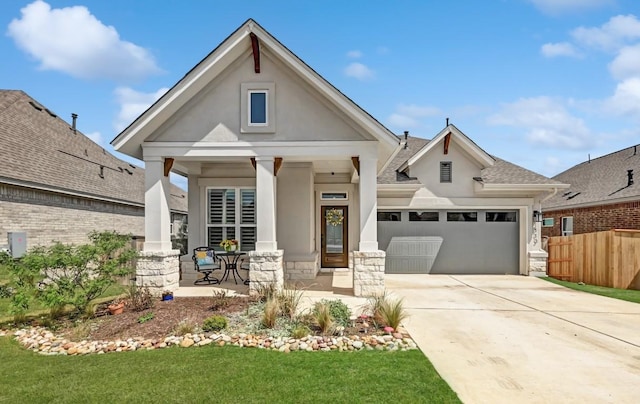 113 Cibolo Creek Loop, Bastrop, TX 78602 - view of front of home with stucco siding, a porch, a garage, concrete driveway, and stone siding