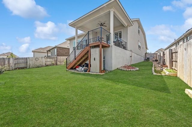 113 Cibolo Creek Loop, Bastrop, TX 78602 - rear view of property featuring a ceiling fan, stairs, a fenced backyard, and stucco siding