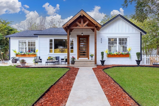 904 Fisher St, Taylor, TX 76574 - view of front of home with board and batten siding and a shingled roof