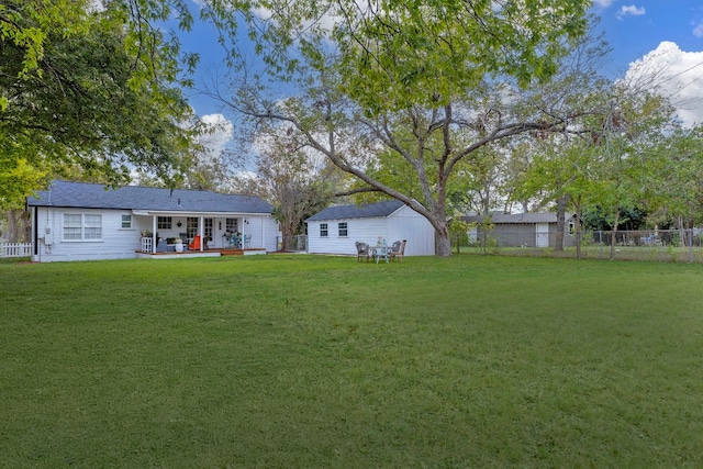 904 Fisher St, Taylor, TX 76574 - back of property featuring a fenced backyard, an outdoor structure, and a patio area