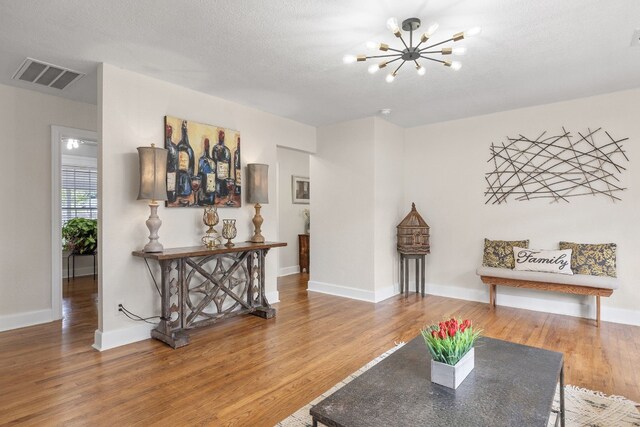 904 Fisher St, Taylor, TX 76574 - living room with wood finished floors and a chandelier