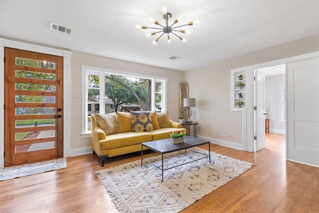 904 Fisher St, Taylor, TX 76574 - living area with light wood finished floors and a chandelier