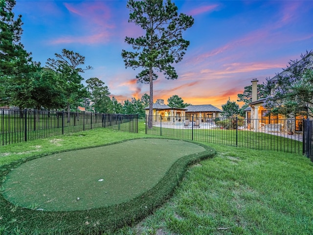 106 Elm Ct, Bastrop, TX 78602 - yard at dusk featuring an area to practice putting
