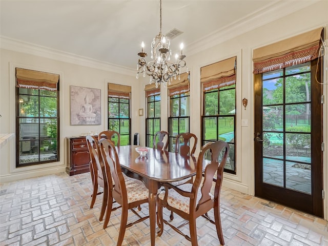 106 Elm Ct, Bastrop, TX 78602 - dining area featuring brick floors, ornamental molding, and a chandelier