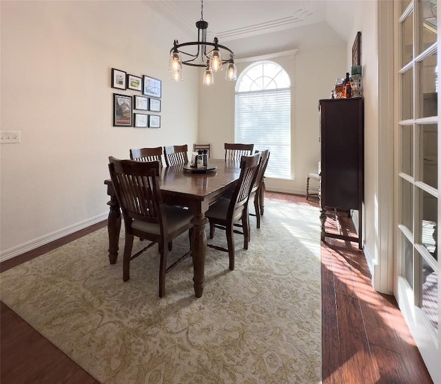 dining room with baseboards, wood finished floors, and a chandelier