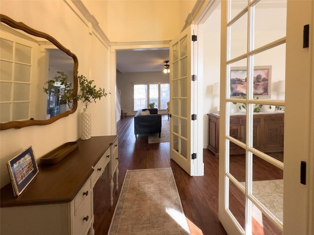 corridor featuring french doors and dark wood-style flooring