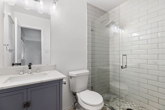 6809 Lunar Dr, Austin, TX 78745 - bathroom featuring a shower stall, vanity, toilet, and a textured wall