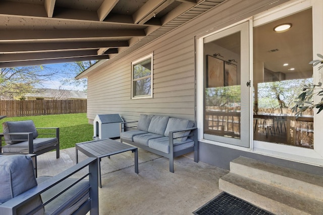 view of patio with an outdoor living space and fence