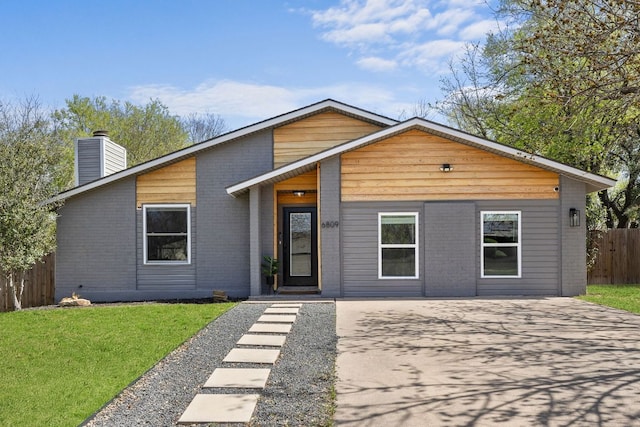 6809 Lunar Dr, Austin, TX 78745 - view of front of property with a chimney, driveway, and brick siding