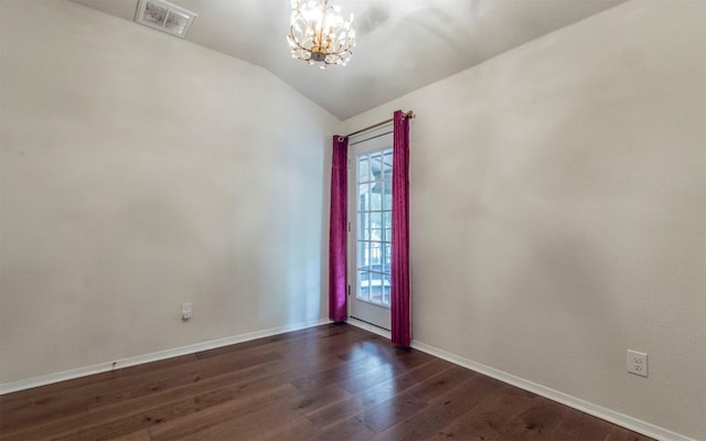 20700 Deep Crk, Lago Vista, TX 78645 - spare room with a chandelier, lofted ceiling, dark wood finished floors, and baseboards