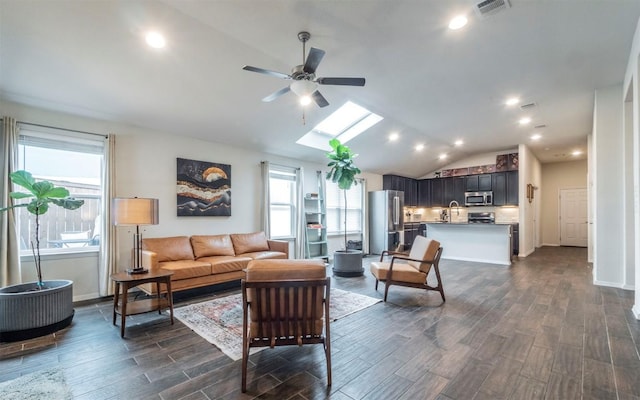 20700 Deep Crk, Lago Vista, TX 78645 - living room featuring a ceiling fan, a skylight, dark wood-style floors, lofted ceiling, and recessed lighting