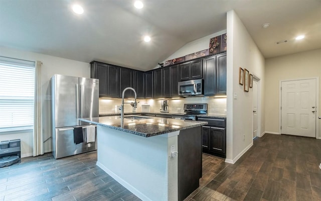 20700 Deep Crk, Lago Vista, TX 78645 - kitchen with stainless steel appliances, a sink, dark wood finished floors, dark stone counters, and tasteful backsplash