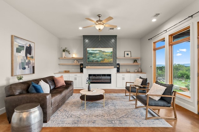 4004 Cloudy Ridge Rd, Austin, TX 78734 - living area with a ceiling fan, a glass covered fireplace, and recessed lighting