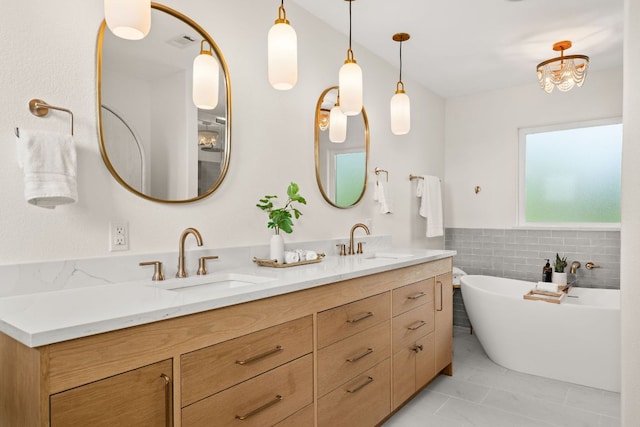 4004 Cloudy Ridge Rd, Austin, TX 78734 - full bath featuring double vanity, a freestanding bath, marble finish flooring, tile walls, and wainscoting