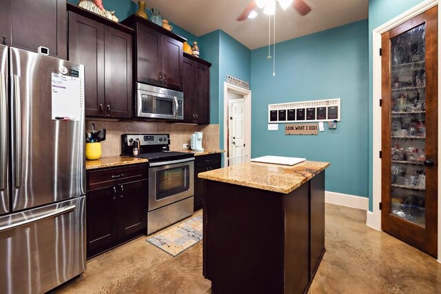 2129 Woodland Bend Rd, Salado, TX 76571 - kitchen with backsplash, light stone countertops, concrete floors, appliances with stainless steel finishes, and ceiling fan