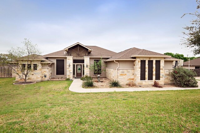 2129 Woodland Bend Rd, Salado, TX 76571 - view of front facade featuring stone siding, roof with shingles, and a front yard