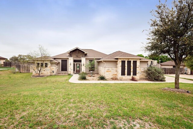 2129 Woodland Bend Rd, Salado, TX 76571 - prairie-style home featuring fence, a front yard, stone siding, and stucco siding