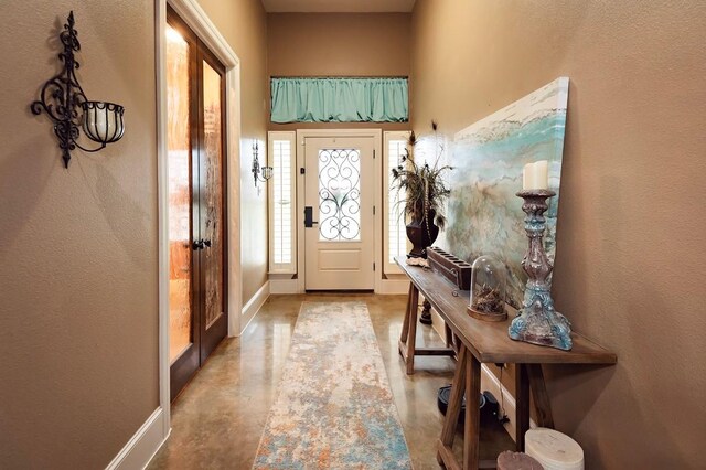 2129 Woodland Bend Rd, Salado, TX 76571 - entrance foyer featuring baseboards, a textured wall, and finished concrete floors