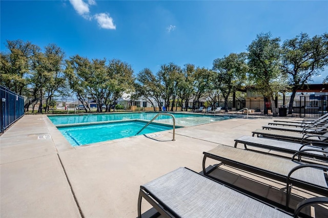 pool featuring fence and a patio