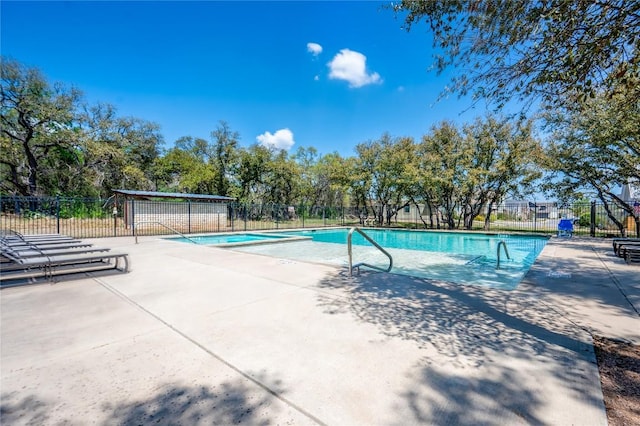 community pool featuring a patio area and fence