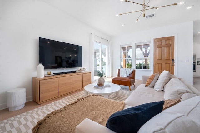 living room with baseboards, visible vents, recessed lighting, and a notable chandelier