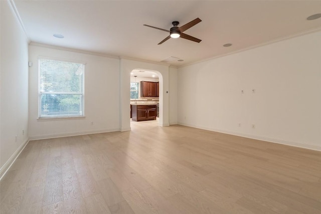 6108 Whipple Way, Austin, TX 78745 - spare room with arched walkways, crown molding, a ceiling fan, and light wood finished floors