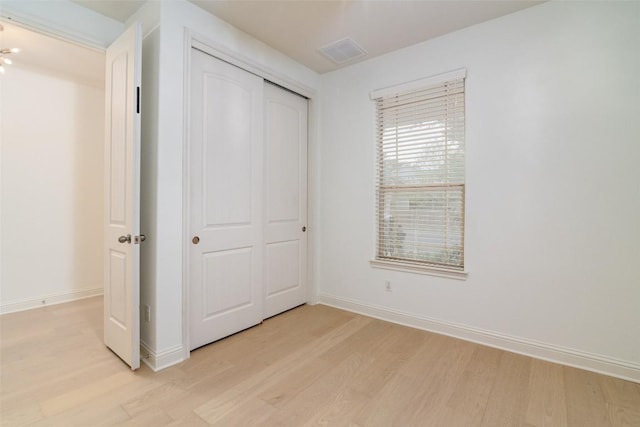 6108 Whipple Way, Austin, TX 78745 - unfurnished bedroom featuring light wood-style floors and a closet