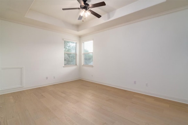 6108 Whipple Way, Austin, TX 78745 - unfurnished room with a raised ceiling, light wood finished floors, and a ceiling fan