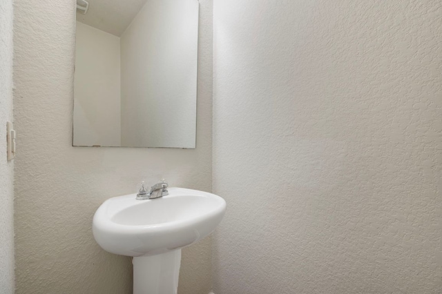 3603 Canaan Matthew Dr, Austin, TX 78725 - bathroom with a textured wall and a sink