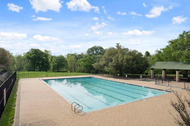 3603 Canaan Matthew Dr, Austin, TX 78725 - community pool featuring a patio area and view of scattered trees
