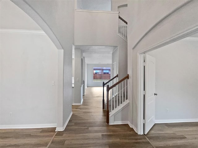 19500 Morgana Dr, Pflugerville, TX 78660 - foyer featuring wood finished floors, baseboards, stairs, crown molding, and arched walkways