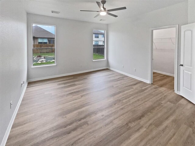 19500 Morgana Dr, Pflugerville, TX 78660 - empty room featuring a ceiling fan, wood finished floors, and baseboards