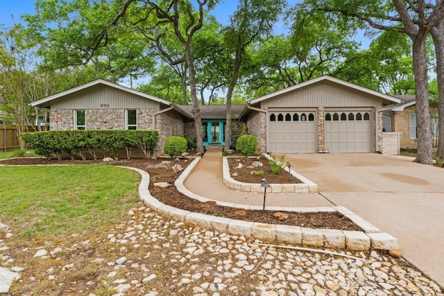 8702 Willowick Dr, Austin, TX 78759 - view of front of home featuring brick siding, a garage, and driveway