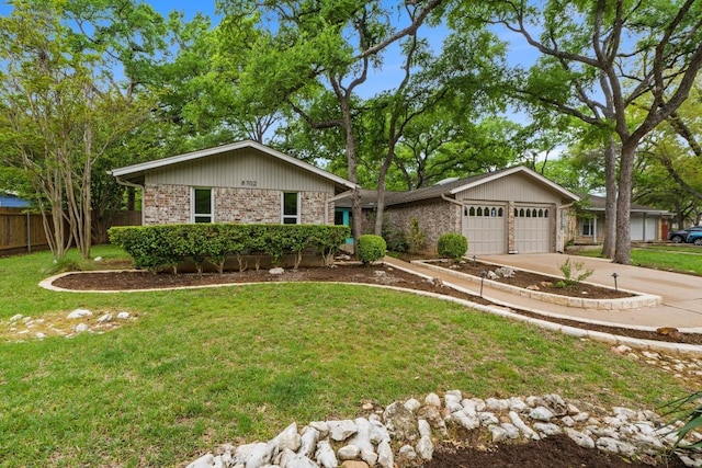 8702 Willowick Dr, Austin, TX 78759 - view of front of house with a garage, driveway, and brick siding