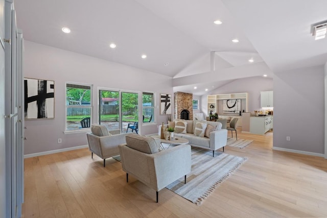 8702 Willowick Dr, Austin, TX 78759 - living room featuring vaulted ceiling, light wood-type flooring, recessed lighting, and a fireplace