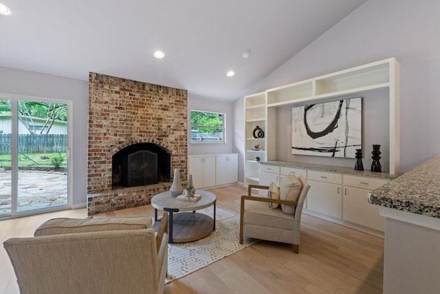 8702 Willowick Dr, Austin, TX 78759 - living area with light wood-style floors, vaulted ceiling, recessed lighting, and a brick fireplace