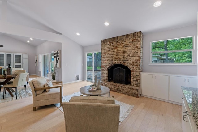 8702 Willowick Dr, Austin, TX 78759 - living area with light wood-type flooring, recessed lighting, lofted ceiling, and a brick fireplace